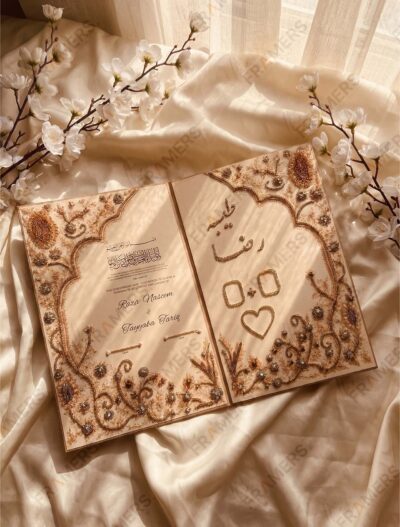 Camel and gold embellished Nikkah booklet opened flat showing hand-beaded embroidery, pearls and personalised names