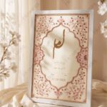 Classic White Nikkah Frame with Rose-Gold Rhinestone Vine & Zardozi, standing on cream silk